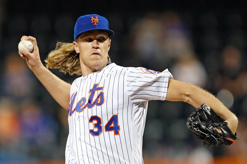 In this Sept. 24, 2019, file photo, Mets starting pitcher Noah Syndergaard winds up during the first inning of a game against the Marlins in New York. 