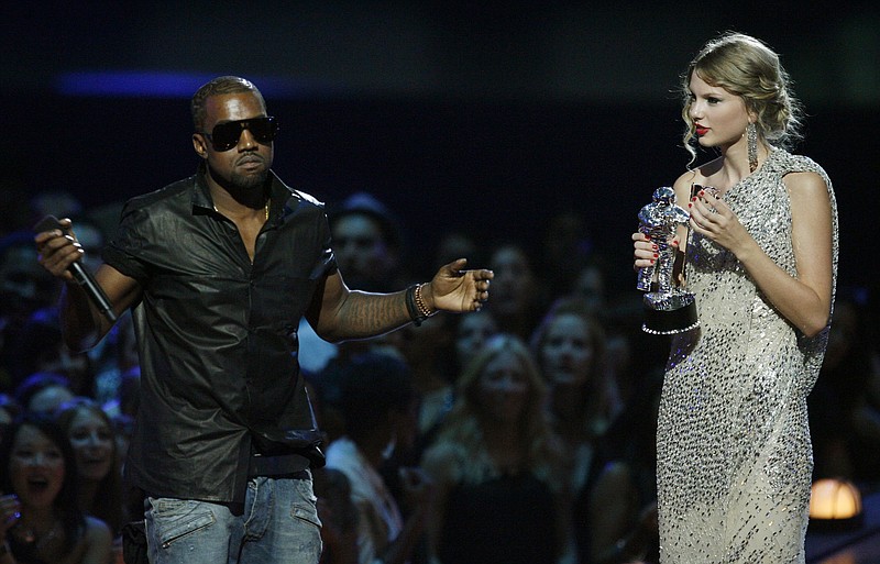 In this Sept. 13, 2009 file photo, singer Kanye West takes the microphone from singer Taylor Swift as she accepts the "Best Female Video" award during the MTV Video Music Awards  in New York.   Swift may have ended her feud with Katy Perry but the one with Kanye West seems simply not to want to die. New leaked video clip of the entire four-year-old phone call between the rapper and pop superstar about his controversial song "Famous" have been posted online and further complicate the picture of what happened.(AP Photo/Jason DeCrow, File)