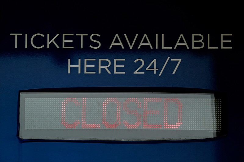 Ticket windows are closed at Kauffman Stadium, home of the Kansas City Royals baseball team, Wednesday, March 25, 2020, in Kansas City, Mo. The start of the regular season, which was set to start on Thursday, is on hold indefinitely because of the coronavirus pandemic. (AP Photo/Charlie Riedel)