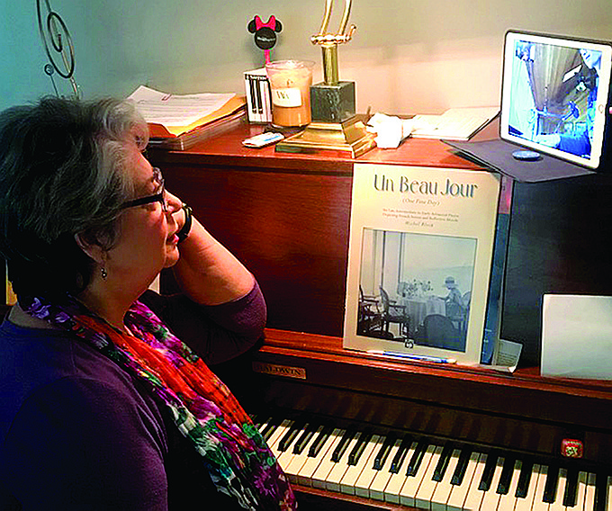 Piano teacher Vicki Carr, above, has moved instruction online because of the coronavirus crisis, which makes for a less intimate form of teaching, she says. 