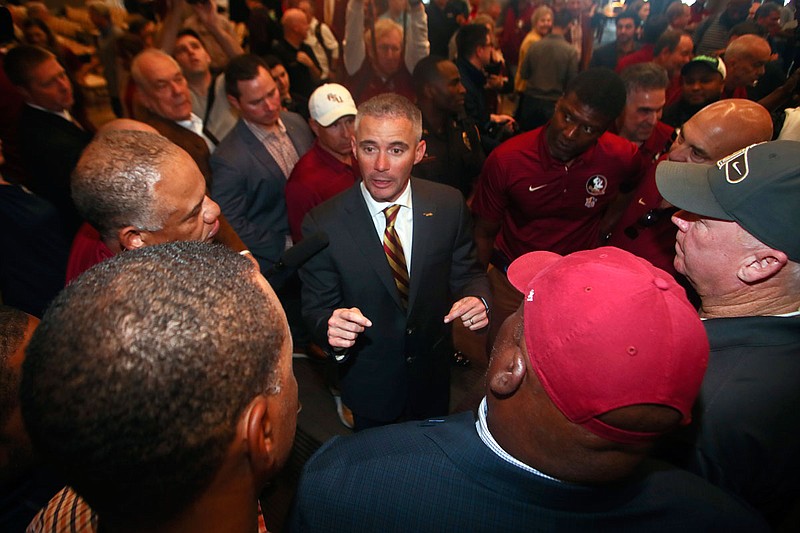 In this Dec. 8, 2019, file photo, new Florida State football coach Mike Norvell talks to football staffers after a news conference in Tallahassee, Fla. 