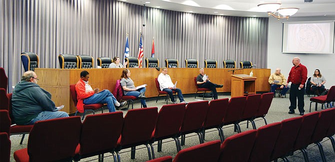 Members of Fulton's municipal government practice social distancing Tuesday evening during an emergency meeting. The meeting formalized emergency measures already in place in Fulton, including the suspension of utility shutoffs.