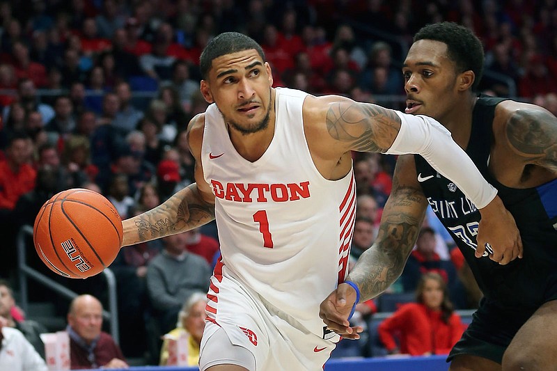 In this Feb 1, 2020, file photo, Dayton's Obi Toppin drives to the basket against St. Louis University forward Jimmy Bell Jr. during the second half of a game in Dayton, Ohio. 