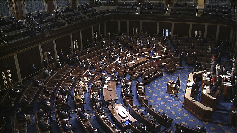 In this image from video, members of the House practice social distancing as they sit on the floor and in the public gallery above during debate on the coronavirus stimulus package on the floor of the House of Representatives at the U.S. Capitol in Washington, Friday, March 27, 2020.