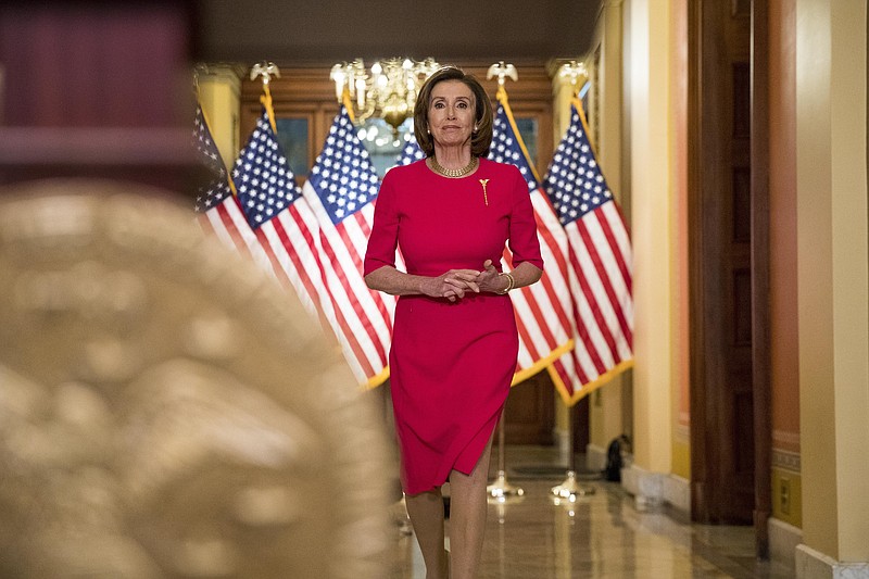 House Speaker Nancy Pelosi of Calif. arrives to read a statement outside her office on Capitol Hill, Monday, March 23, 2020, in Washington. (AP Photo/Andrew Harnik, Pool)