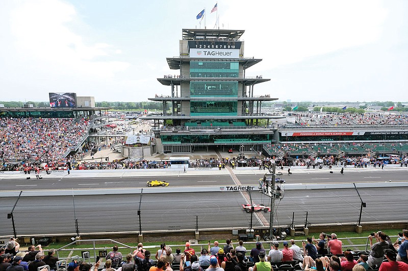 In this May 24, 2019, file photo, cars take to the track during the final practice session for the Indianapolis 500 at Indianapolis Motor Speedway in Indianapolis. The Indianapolis 500 scheduled for May 24 has been postponed until August because of the coronavirus pandemic and won't run on Memorial Day weekend for the first time since 1946. 