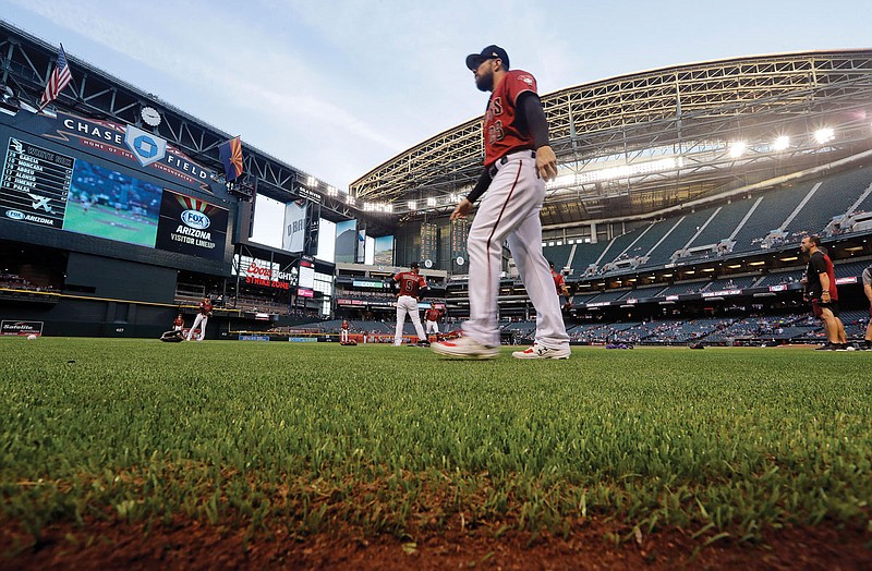In this March 25, 2019, file photo, Steven Souza Jr. of the Diamondbacks  walks on new turf at the team's home field before an exhibition game against the White Sox in Phoenix. If baseball does resume this season, there could be some radical scheduling solutions as MLB tries to squeeze in as many games as possible. 