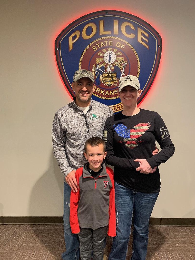 Billy and Holly Smith with their son Ian at the Texarkana, Arkansas Police Department in December. At that time, Holly was tumor free after being diagnosed with Glioblastoma last spring.