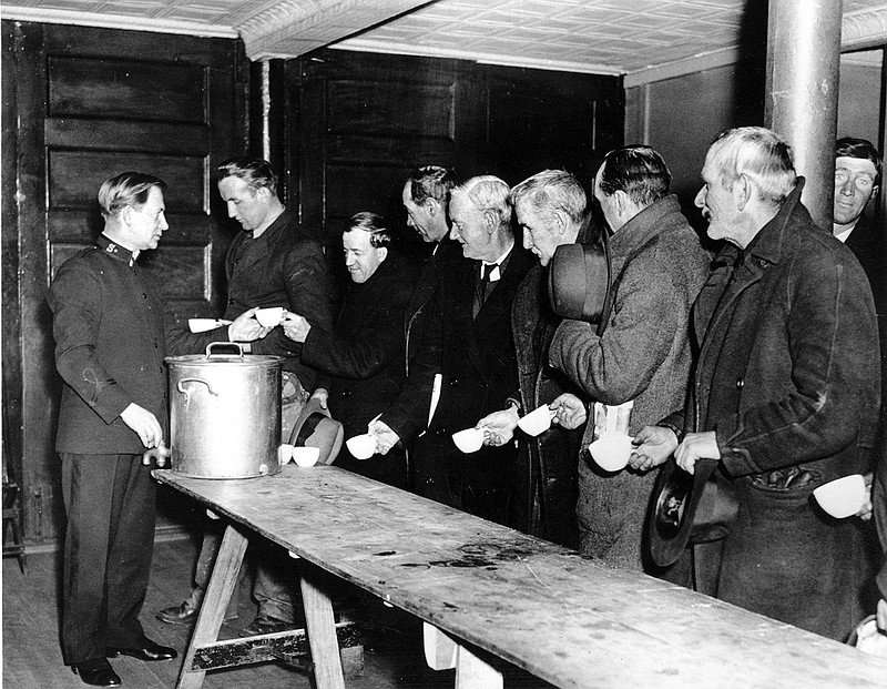 A Salvation Army relief worker tends to a line at a local soup kitchen during the Great Depression. Nearly a century later, the U.S. economy is all but shut down, and layoffs are soaring at small businesses and major industries. A devastating global recession looks inevitable. Deepening the threat, a global oil price war has erupted. Some economists foresee an economic downturn to rival the Depression. (AP Photo)