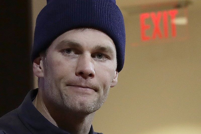 In this Jan. 4, 2020, file photo, New England Patriots quarterback Tom Brady listens to a question at his post-game news conference after the Patriots lost to the Tennessee Titans in an NFL wild-card playoff football game in Foxborough, Mass. Brady said on social media, Friday, March 20, 2020, he has signed with with the Tampa Bay Buccaneers. (AP Photo/Elise Amendola, File)