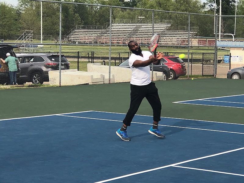 De'Shun Bayne returns a ball to his girlfriend, Emma Land, on Thursday at Dragon Court at Redwater High School. The couple played tennis for the first time in months on a sunny day.
