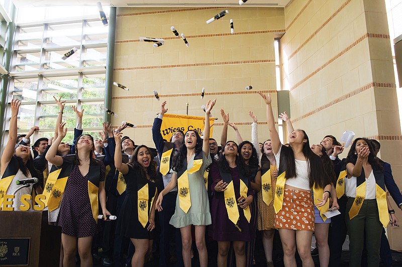 In this March 13, 2020, photo, senior residents of Rice's Wiess College perform a mock commencement ceremony at the school in Houston. Due to the coronavirus outbreak it's not clear whether the campus will reopen in time for graduation. The new coronavirus causes mild or moderate symptoms for most people, but for some, especially older adults and people with existing health problems, it can cause more severe illness or death. (Jeff Fitlow/Rice University via AP)