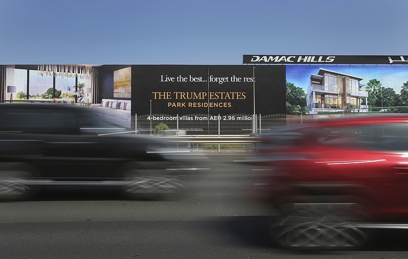 FILE - In this Aug. 9, 2017, file photo, cars pass a giant billboard adverting DAMAC Properties' Trump Estates golf course villas in Dubai, United Arab Emirates. DAMAC Properties, Dubai's largest, fully private real estate developer, on Sunday, March 29, 2020, posted its first yearly loss since becoming a publicly traded company in 2013, a worrying sign for the sheikhdom's already-reeling vital property market now struggling with the new coronavirus pandemic. (AP Photo/Kamran Jebreili, File)