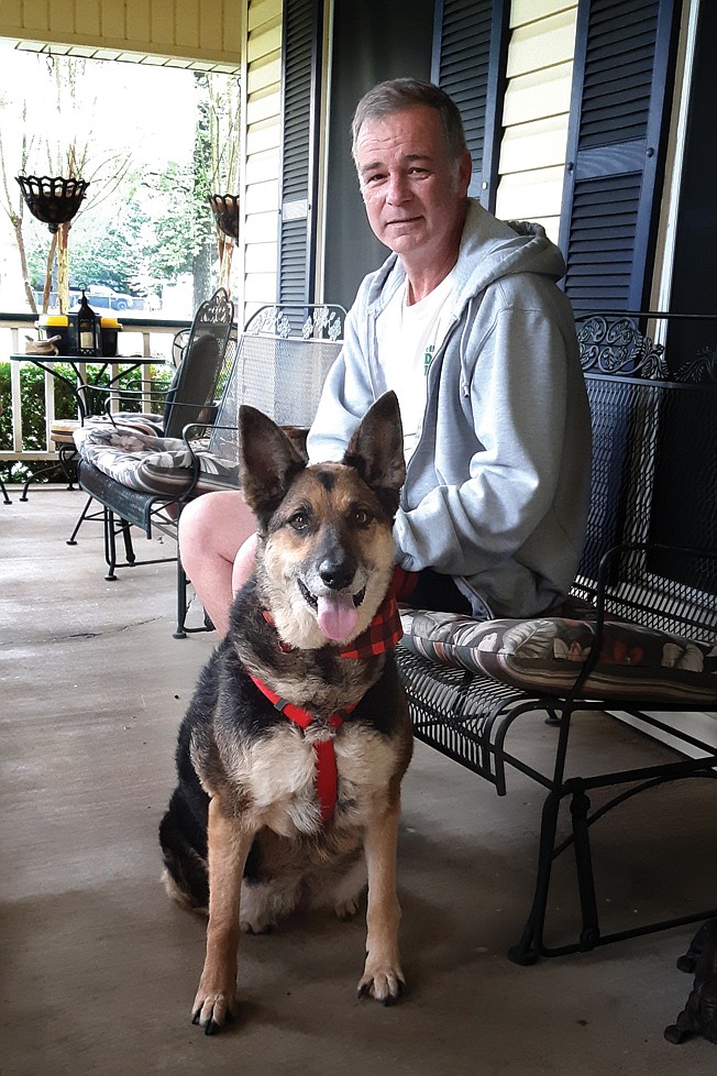 Jeff Tarpley of Jeff Tarpley Dog Rescue poses with Cilla, a female German shepherd who loves a good game of ball. "Much of our business is caring for animals that have lost their owner to death, have had to go into assisted living or otherwise have lost their owner," Tarpley said. 