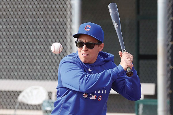 Cubs minor league hitting coach Rachel Folden hits ground balls last month at the team spring trainng facility in Mesa, Ariz. Folden figured something out early on during her first spring training with the Cubs, long before the coronavirus pandemic wiped out team activities. None of the players care all that much that one of their coaches is a woman.