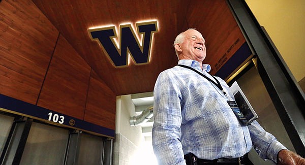 In this Aug. 28, 2013, file photo, former Washington head coach Jim Lambright smiles as he stands at a concourse entrance in the newly renovated Husky Stadium in Seattle.