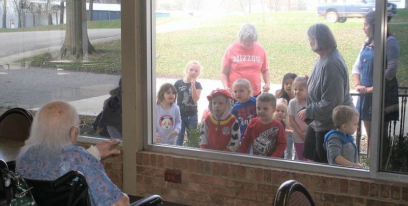 California Care Center residents watch special visitors from St. Paul's Daycare.