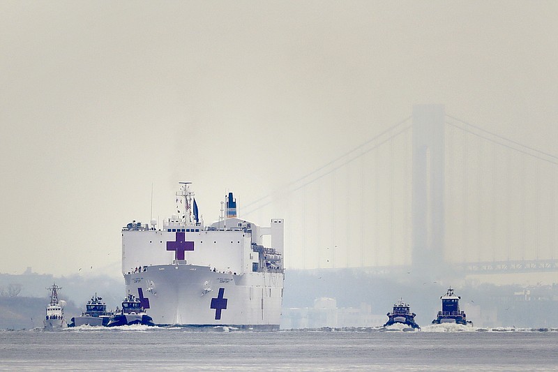 The Navy hospital ship USNS Comfort arrives in New York, Monday, March 30, 2020. The ship has 1,000 beds and 12 operating rooms that could be up and running within 24 hours of its arrival on Monday morning. It's expected to bolster a besieged health care system by treating non-coronavirus patients while hospitals treat people with COVID-19. (AP Photo/Seth Wenig)