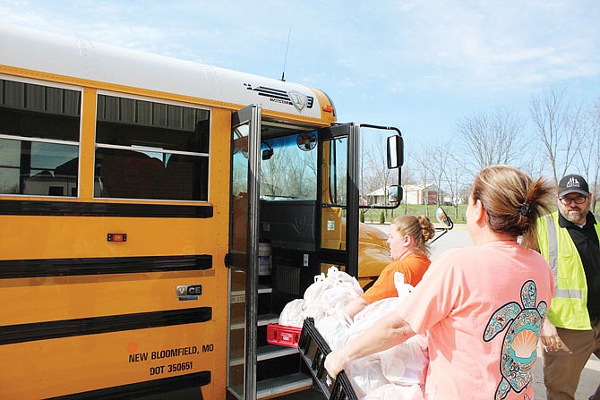 New Bloomfield R-II School District staff load lunches for students onto school buses.