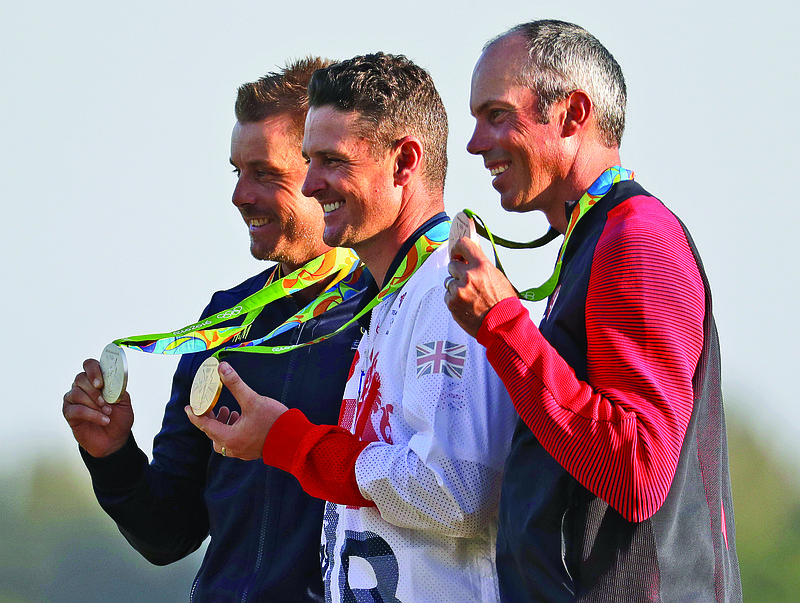 In this Aug. 14, 2016, file photo, standing from left are silver medalist Henrik Stenson, gold medalist Justin Rose and bronze medalist Matt Kuchar after the final round of the men's golf event at the Summer Olympics in Rio de Janeiro, Brazil.