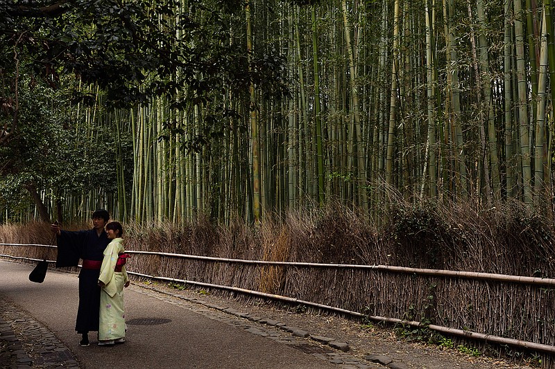 A couple takes a selfie at the Arashiyama Bamboo Forest in Kyoto, Japan, March 18, 2020. Widening travel restrictions and closures of most tourism and entertainment venues have gutted the tourism industry in many parts of the world, as well as in Japan.(AP Photo/Jae C. Hong)