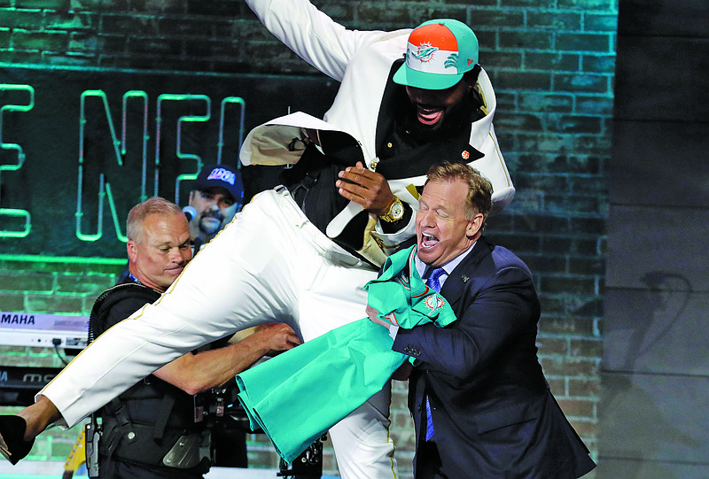 In this April 25, 2019, file photo, Clemson defensive tackle Christian Wilkins moves into NFL commissioner Roger Goodell after the Dolphins selected Wilkins in the first round at the NFL Draft in Nashville, Tenn.