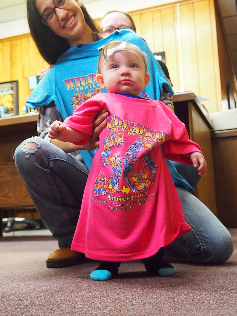 In Linden, Texas, 8-month old Alayna models the 2020 festival Texas Wildflower Trails T-shirt for her aunt Lupita Jones. Alayna's mother, Sam Jones, is looking over Lupita's shoulder. Linden, Avinger and Hughes Springs are getting ready to celebrate the 50th anniversary of the Texas Wildflower Trails on April 28.
