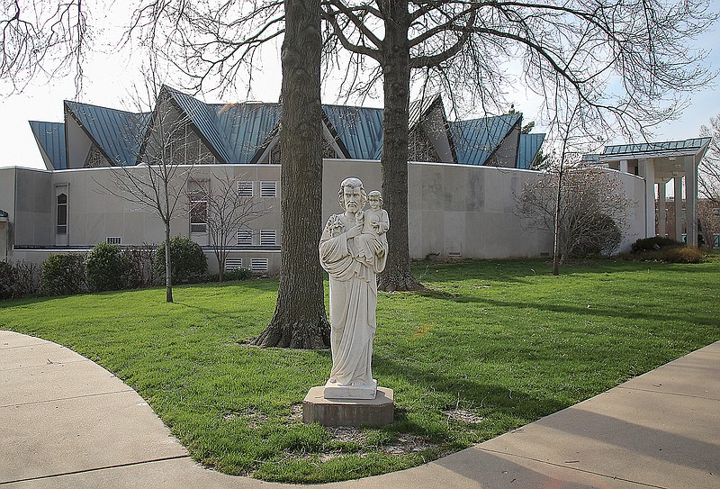 A statue of St. Joseph holding baby Jesus stands Wednesday afternoon, April 1, 2020, outside St. Joseph Cathedral Church in Jefferson City. 