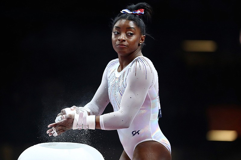 In this Oct. 10, 2019, file photo, Simone Biles of the United States gets ready to perform on the uneven bars in the women's all-around final at the Gymnastics World Championships in Stuttgart, Germany. Biles is pressing on to the 2021 Olympics. While she's confident her body will be fine next summer, she is concerned about the mental toll of another year of training.  (AP Photo/Matthias Schrader, Fle)