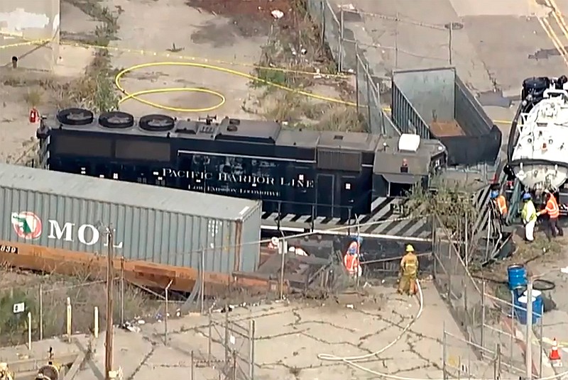 This aerial image taken from video provided by KABC-TV shows a Pacific Harbor Line train that derailed Tuesday, March 31, 2020, at the Port of Los Angeles after running through the end of the track and crashing through barriers, finally coming to rest about 250 yards from the docked U.S. Navy Hospital Ship Mercy. The train engineer intentionally drove the speeding locomotive off a track at the Port of Los Angeles because he was suspicious about the presence of a Navy hospital ship docked there amid the coronavirus crisis. (KABC-TV via AP)