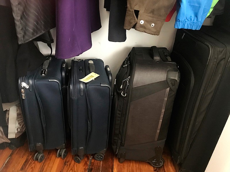 Empty suitcases sit in Julie Pace's closet in Washington, Tuesday, March 31, 2020. The suitcases, usually on the bedroom floor half-unpacked between trips, have been put away for now. (AP Photo/Julie Pace)