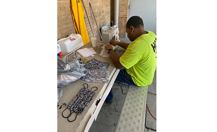 An inmate at Hempstead County jail works on masks for county employees. Sheriff James Singleton bought material to make masks to protect deputies from COVID-19. Photo courtesy Hempstead County Sheriff's Office