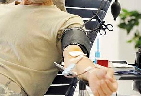 In this June 2011 News Tribune file photo, a donor gives blood at the Red Cross office in Jefferson City.