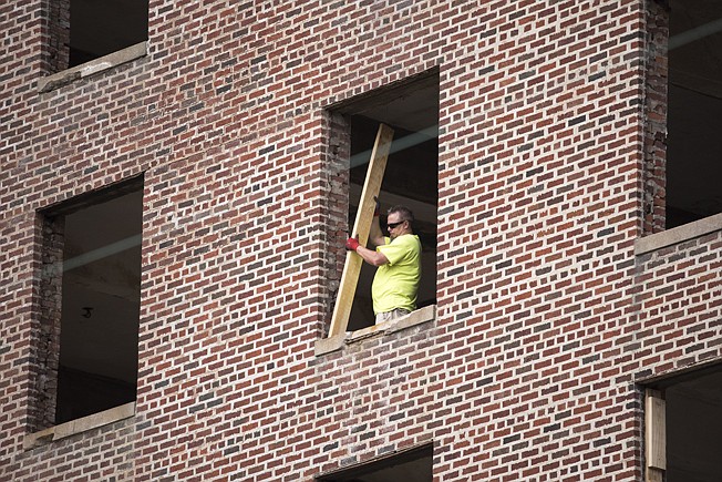 Work on the Hotel Grim continues Tuesday afternoon in downtown Texarkana despite the COVID-19 pandemic. Most of the subcontractors are able to safely distance themselves from one another, said Tim Minson, Cohen-Esrey Development Group project manager. "No one's backed down," he said. "The employees have to work to feed their families."