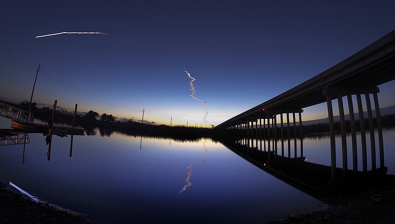 In this file photo, a United Launch Alliance Atlas V rocket streaks across the horizon at dawn in this view from the St. Johns River, east of Sanford, Fla., on Dec. 20, 2019. After a failed December test flight of its astronaut capsule revealed multiple deep-seated problems within Boeings testing procedures, the company has decided to repeat the test before putting astronauts on board. (Joe Burbank/Orlando Sentinel/TNS)