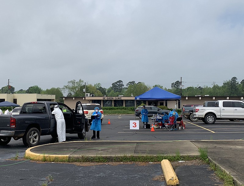 Lansdell Family Clinic employees and other volunteers screen and test people for COVID-19 Wednesday morning in the parking lot of the former De Queen Medical Center. (Staff photo by Lori Dunn)