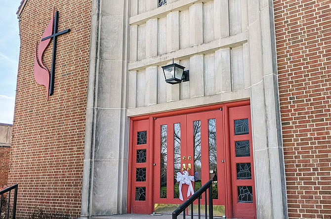White ribbons hang on the doors of Court Street United Methodist Church. They symbolize support for those on the front lines of fighting the COVID-19 pandemic.