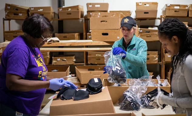 From left, Cora Lewis, First Assistant Bowie County District Attorney Kelley Crisp and Michele Roberts label and bag reusable cloth masks Friday at Mayo Manufacturing in Texarkana, Texas. The furniture company is donating disposable and reusable masks and medical-type gowns to first responders in the area. (Courtesy of Patrick Mayo)
