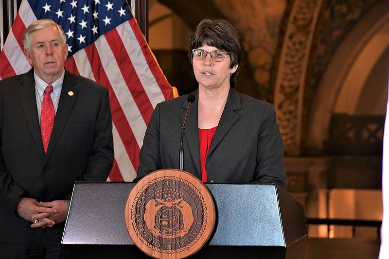 Missouri Department of Public Safety Director Sandra Karsten speaks Tuesday, April 14, 2020, during a COVID-19 news briefing as Gov. Mike Parson looks on.