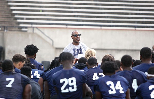 Lincoln head coach Malik Hoskins talks with his players at the end of a practice in September 2019 at Dwight T. Reed Stadium.