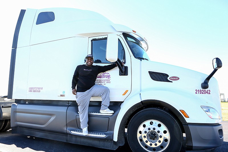 Kaycii Davenport poses with one of the Southern Refrigerated Transport trucks on Saturday, December 22, 2018, at the Southern Refrigerated Transport in Texarkana, Arkansas. 