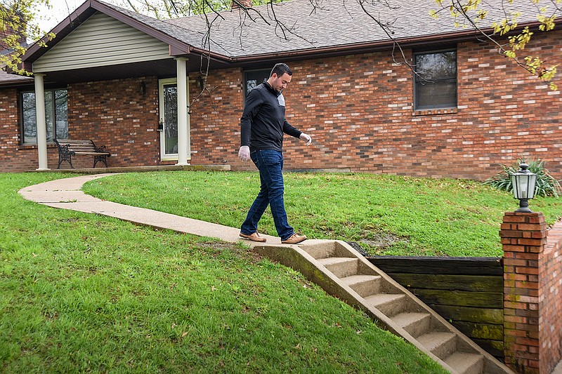 Logan Gratz, of Gratz Real Estate in Jefferson City, prepares a house to show on the city's east side. Gratz Real Estate has outlined policies and procedures, listed on the company's website regarding listing a house for sale, showing a house, closing and assorted related activities involved in buying or selling a home.