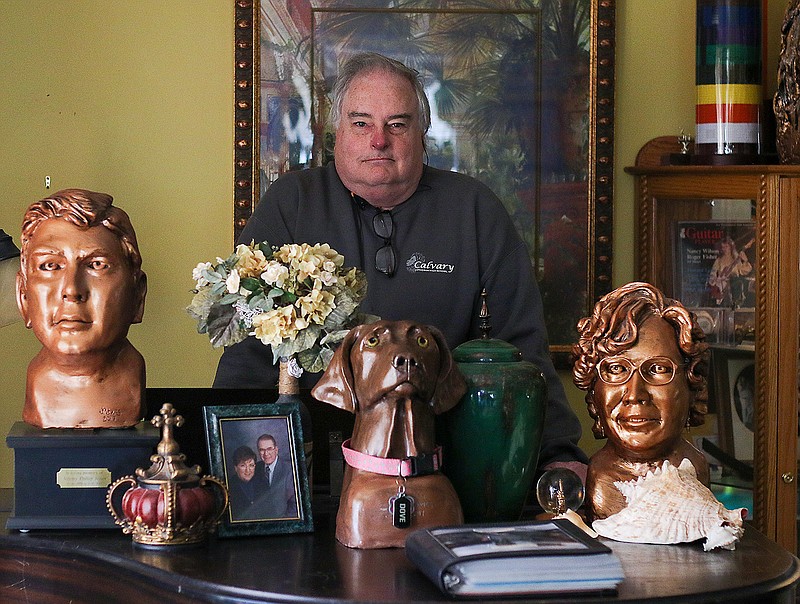 Phil Jones stands amid some of his sculptures Friday in his home. Jones has been creating sculptures since he was a teenager. Now, he works as an art teacher at Calvary Lutheran High School.