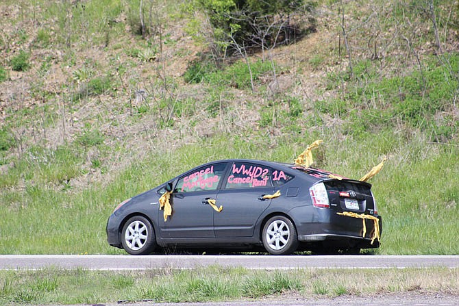 FILE: Dozens of Missourians pulled over alongside Interstate 70 between Kansas City and St. Louis in April 2020 to call for action on housing issues. One participant stopped near Kansas City.