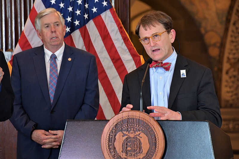 Dr. Randall Williams, director of the Missouri Department of Health and Senior Services, speaks during a COVID-19 briefing Wednesday, April 22, 2020, as Gov. Mike Parson looks on.