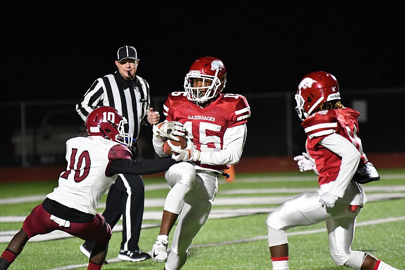 Arkansas High wide receiver Jalen Pastchol (15) tries to protect the ball under pressure from Hope Bobcats cornerback Kenya Wesley (10) on Nov. 1 at Razorback Stadium in Texarkana, Ark. (Photo by Kevin Sutton)
