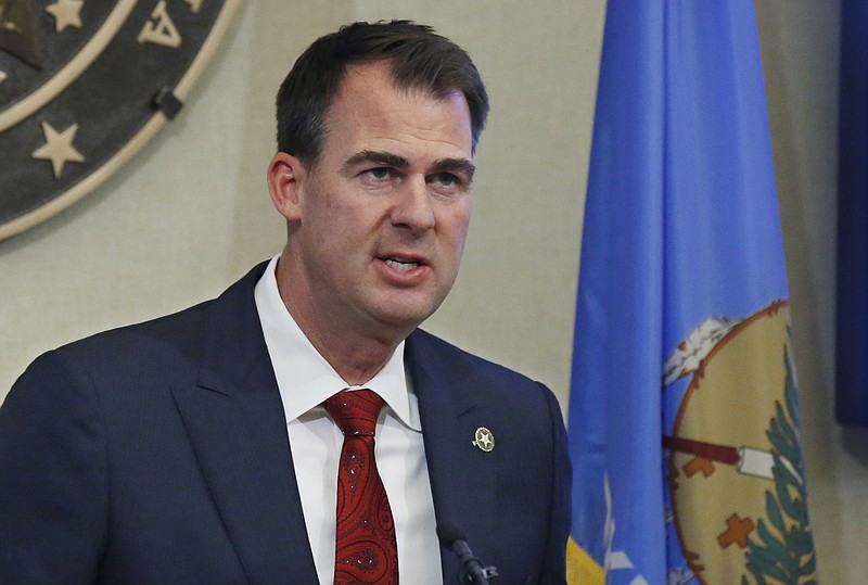 Oklahoma Gov. Kevin Stitt announces plans to reopen Oklahoma businesses after closures due to the coronavirus outbreak, Wednesday, April 22, 2020, in Oklahoma City. Stitt said barbershops, hair salons and other personal care businesses can reopen Friday, April 24, if they maintain social distancing and serve customers by appointment only. (AP Photo/Sue Ogrocki)