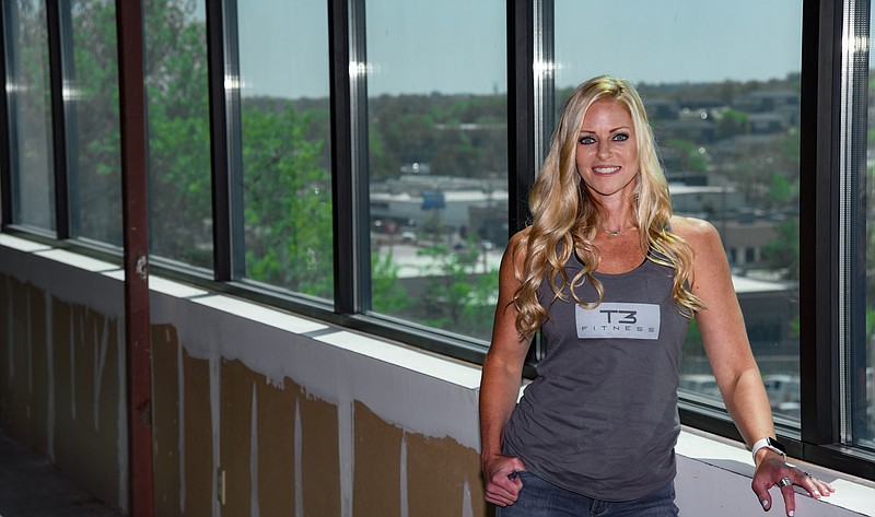 Julie Smith/News Tribune
Holly Geisler, owner of T3 Fitness, poses for a photograph in what will be the yoga studio of her new three-story fitness facility on Heisinger Road, just off of Missouri Boulevard. Geisler is excited for clients to be able to see the view from the third floor windows that overlook Missouri Boulevard and places south. The building was orignally home to Culligan Water of Jefferson City and has been empty for several years. The most recent renter was local artist Dennis Holliday who used the location for an art studio.