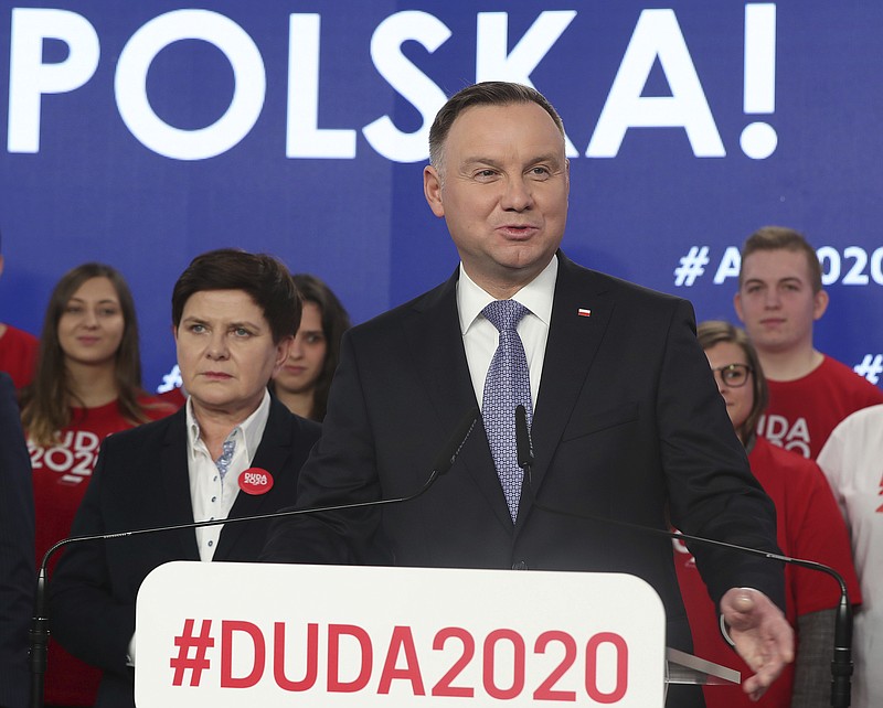 FILE - In this file photo taken Feb. 19, 2020, Poland's President Andrzej Duda, center, campaigning for his re-election in Warsaw, Poland.  The Polish government’s determination to move forward with the May 10, presidential election during the coronavirus pandemic by making it an all-postal vote is creating anxiety and anger, and critics say the plan threatens public health and democracy in Poland.(AP Photo/Czarek Sokolowski)