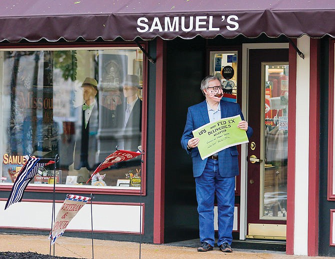 Sam Bushman, owner of Samuel's Tuxedos, stands outside his business on High Street less than a minute before Cole County's stay-at-home order expired in April 2020.